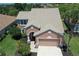 Two-story home with a two-car garage and well-maintained landscaping and a mature palm in the front yard at 5275 Layton Dr, Venice, FL 34293