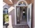 Entrance of a home featuring an open front door, brick pavers, and decorative glass at 5275 Layton Dr, Venice, FL 34293