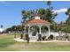 Picturesque park gazebo with a red tile roof, set on a lush green lawn in Venice, Florida at 5275 Layton Dr, Venice, FL 34293