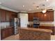 Updated kitchen with stainless steel appliances, wooden cabinets, and a center island at 5275 Layton Dr, Venice, FL 34293