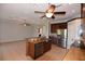 Open kitchen with stainless steel appliances, wooden cabinets, and a center island at 5275 Layton Dr, Venice, FL 34293