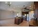 Open kitchen with stainless steel appliances, wooden cabinets, and a center island at 5275 Layton Dr, Venice, FL 34293