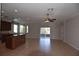 Expansive living space with kitchen island, ceiling fans and sliding glass doors to the patio at 5275 Layton Dr, Venice, FL 34293