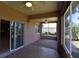 Spacious screened-in patio with tiled flooring and views of the green backyard at 5275 Layton Dr, Venice, FL 34293