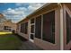 Exterior view of a screened-in porch with tan siding at 5275 Layton Dr, Venice, FL 34293