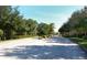 A street view lined with mature trees leads to a well-maintained neighborhood at 5275 Layton Dr, Venice, FL 34293