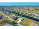 Aerial view of the home situated on a waterfront canal lot in a sprawling community at 102 Annapolis Ln, Rotonda West, FL 33947