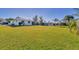 Expansive backyard showing the full width of the house and green lawn at 102 Annapolis Ln, Rotonda West, FL 33947
