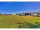 Backyard features a large green lawn and ample space between neighboring houses at 102 Annapolis Ln, Rotonda West, FL 33947