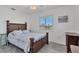 Bedroom with hardwood bed frame, white walls, and a view of the outside through the window at 102 Annapolis Ln, Rotonda West, FL 33947