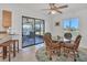 Dining area with wicker chairs, a glass table, and a ceiling fan for comfortable dining at 102 Annapolis Ln, Rotonda West, FL 33947