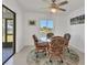 Dining area with wicker chairs, a glass table, and sliding glass door to the backyard at 102 Annapolis Ln, Rotonda West, FL 33947
