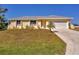 Charming single-story home with a well-manicured lawn and a two-car garage at 102 Annapolis Ln, Rotonda West, FL 33947