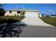 Charming one-story home with a well-manicured lawn, a freshly painted driveway, and a two-car garage at 102 Annapolis Ln, Rotonda West, FL 33947