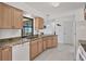 Kitchen features granite countertops, light wood cabinets and marble-look tile flooring at 102 Annapolis Ln, Rotonda West, FL 33947