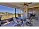 Enclosed lanai with ceiling fan features a glass-top table and views of the waterway at 102 Annapolis Ln, Rotonda West, FL 33947