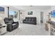 Bright and airy living room featuring tile floors, modern furniture, and a large window at 102 Annapolis Ln, Rotonda West, FL 33947