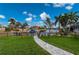 A beautifully landscaped backyard features a private boat dock with Gulf access and tropical landscaping at 1380 Willet Ct, Punta Gorda, FL 33950