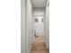 Hallway view of a bathroom featuring a freestanding tub and wood look floors at 1380 Willet Ct, Punta Gorda, FL 33950