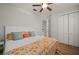 Comfortable bedroom with wood floors, ceiling fan, and bright floral comforter at 1380 Willet Ct, Punta Gorda, FL 33950