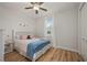 Cozy bedroom featuring wood floors, a ceiling fan, and bright natural light at 1380 Willet Ct, Punta Gorda, FL 33950
