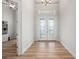 Welcoming foyer with wood-look flooring, and glass double doors at 1380 Willet Ct, Punta Gorda, FL 33950