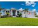 Beautiful home with a well-maintained front yard, manicured bushes, and a paver driveway at 1380 Willet Ct, Punta Gorda, FL 33950