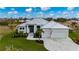Stunning house with a manicured lawn, beautiful landscaping, and a white paver driveway at 1380 Willet Ct, Punta Gorda, FL 33950