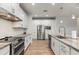 Spacious modern kitchen featuring stainless steel appliances and ample white cabinet storage at 1380 Willet Ct, Punta Gorda, FL 33950