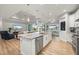 Open concept kitchen with island, stainless appliances, and seamless flow to living and dining areas at 1380 Willet Ct, Punta Gorda, FL 33950