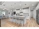 Bright, open kitchen with a large island, modern appliances, pendant lighting, and seamless flow to the dining area at 1380 Willet Ct, Punta Gorda, FL 33950