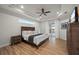 Relaxing main bedroom with a tray ceiling, wood flooring, and access to the pool area at 1380 Willet Ct, Punta Gorda, FL 33950