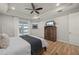 Serene main bedroom featuring a tray ceiling, wood floors, a dresser, and access to outdoor view at 1380 Willet Ct, Punta Gorda, FL 33950