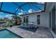 Enjoy outdoor dining on this spacious patio with a view of the canal from the screened-in lanai at 1380 Willet Ct, Punta Gorda, FL 33950