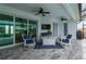 Relax in this covered lanai with a ceiling fan, outdoor seating, and a backyard pool at 1380 Willet Ct, Punta Gorda, FL 33950