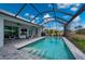 Relax by the pool in the screened-in lanai with a beautiful patio and lovely backyard at 1380 Willet Ct, Punta Gorda, FL 33950