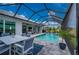A screened-in lanai features a pool, spa and outdoor dining area, perfect for relaxation and entertaining at 1380 Willet Ct, Punta Gorda, FL 33950