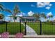 Beautiful backyard featuring a covered lanai, tropical landscaping, and black aluminum fence at 1380 Willet Ct, Punta Gorda, FL 33950