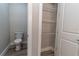 Bathroom featuring a toilet next to an open closet with metal wire shelving at 16305 Branco Dr, Punta Gorda, FL 33955