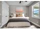 Relaxing bedroom featuring a plush bed with decorative pillows and a large window at 16305 Branco Dr, Punta Gorda, FL 33955