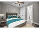 Comfortable bedroom with bed, lamps, and windows, featuring hardwood floors and decor at 16305 Branco Dr, Punta Gorda, FL 33955