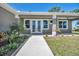 Close-up of the front entrance, featuring double doors and manicured landscaping at 16305 Branco Dr, Punta Gorda, FL 33955