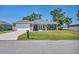 Charming one-story home with a well-manicured lawn and a two-car garage at 16305 Branco Dr, Punta Gorda, FL 33955