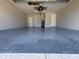Spacious garage with epoxy flooring, overhead lighting and two access doors at 16305 Branco Dr, Punta Gorda, FL 33955
