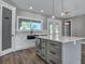Contemporary kitchen showcasing a center island with breakfast bar and pendant lighting at 16305 Branco Dr, Punta Gorda, FL 33955