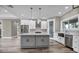 Bright kitchen with stainless appliances, center island, and wood flooring at 16305 Branco Dr, Punta Gorda, FL 33955