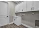 White laundry room with washer and dryer hookups and white cabinets and countertop at 16305 Branco Dr, Punta Gorda, FL 33955