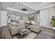 Spacious living room with stylish furniture, a ceiling fan, and a modern entertainment center at 16305 Branco Dr, Punta Gorda, FL 33955