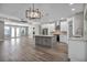 Island kitchen within open floorplan featuring stainless steel appliances and light fixtures at 16305 Branco Dr, Punta Gorda, FL 33955