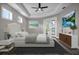 Bright main bedroom with tray ceiling, French doors, and stylish decor offers a relaxing retreat at 16305 Branco Dr, Punta Gorda, FL 33955